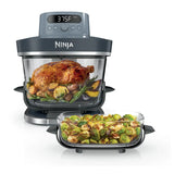 Glass air fryer with a roast chicken and a smaller glass container
